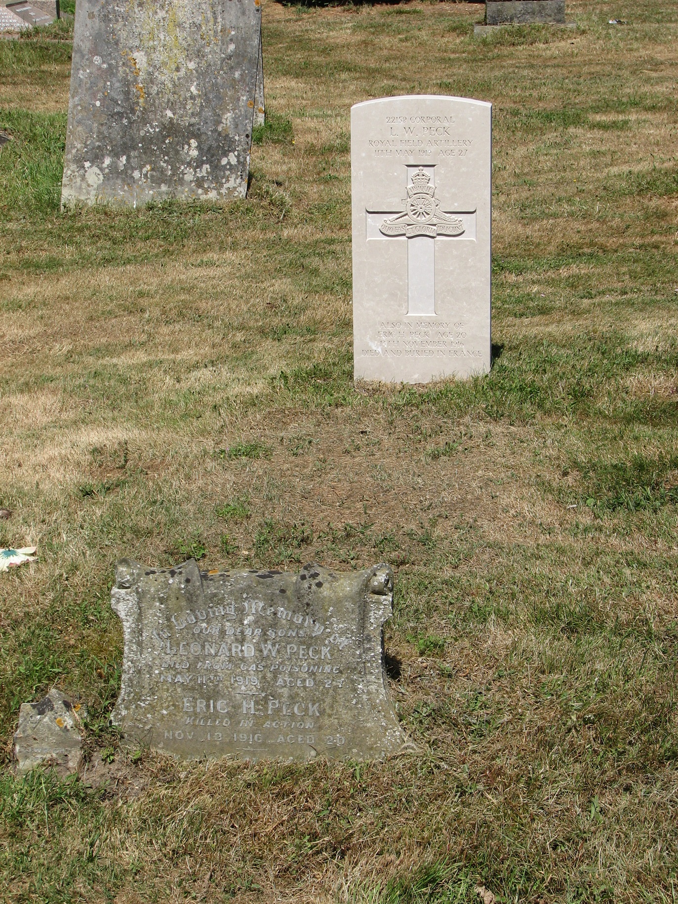 Leonard's grave in East Bergholt Cemetery<br>Showing the "new" (Commonwealth War Graves Commission) headstone and - at the foot of Leonard's grave - the original headstone that had been erected by his family.<br />MA