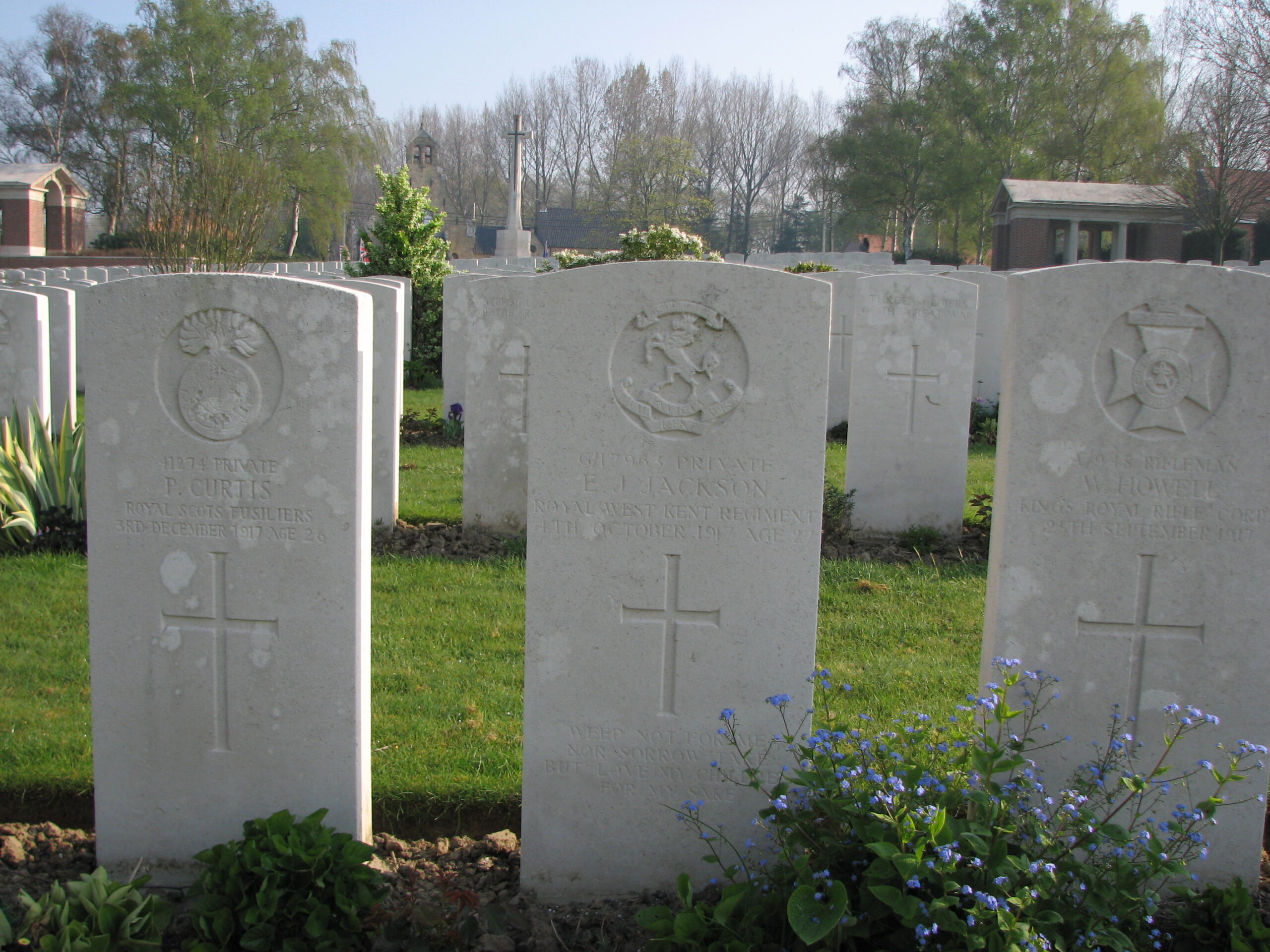 Ernest's headstone (centre) in Hooge Crater Cemetery<br>MA