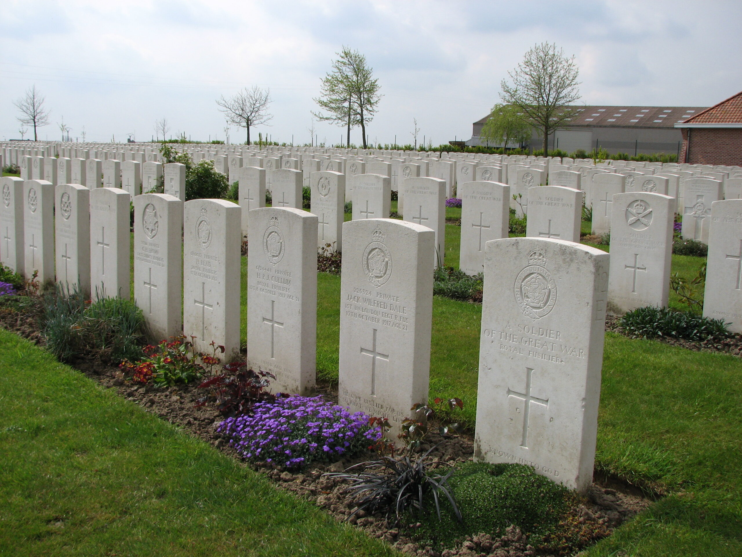 Jack's headstone (second from right) and those of at least two (and probably three) of his comrades who were killed on the same day.  Quite possibly, they were all killed together.<br>It is interesting to note that Jack's comrades headstones correctly state their Regiment as the Royal Fusiliers.<br />MA