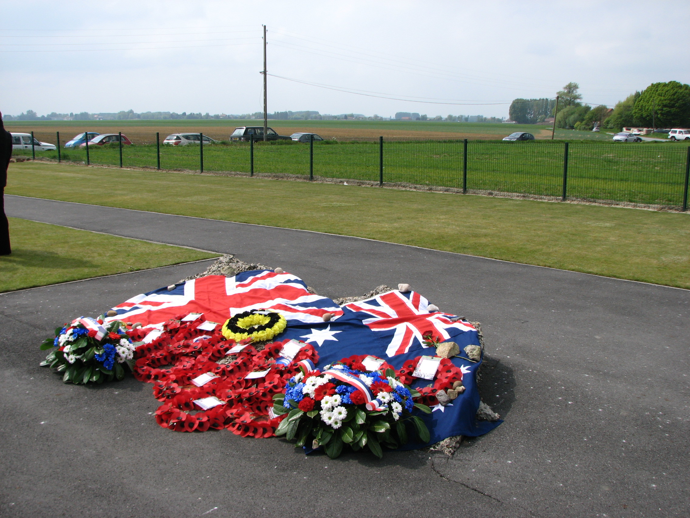 Wreaths laid at the Memorial Service to mark the 95th Anniversary of the Battle of Aubers Ridge.  9th May 2010.<br>In the far distance can be seen the site of the 2nd Northamptons attack on 9th May 1915, where Walter Southgate and Andrew Thurlow lost their lives. <br />MA